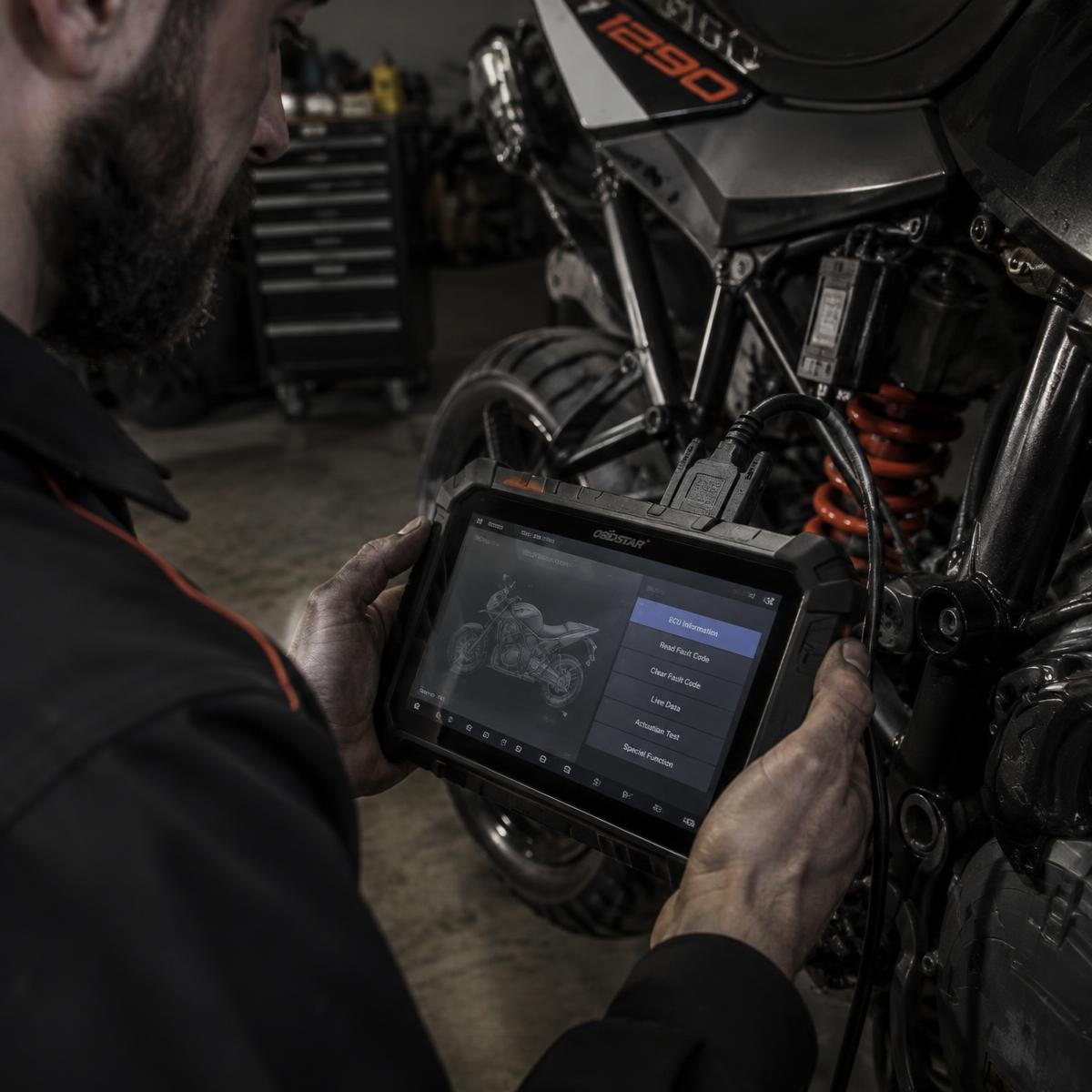 Technician using a professional diagnostic tablet on a motorcycle